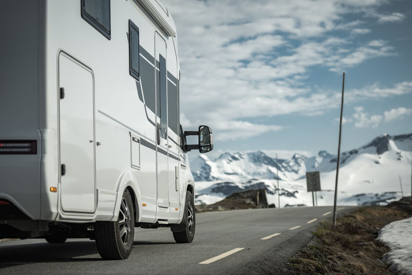 RV traveling down mountain road in the winter