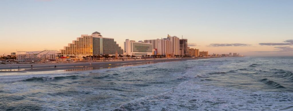 Panoramic view of Daytona Beach and tall buildings along the coastline at sunset