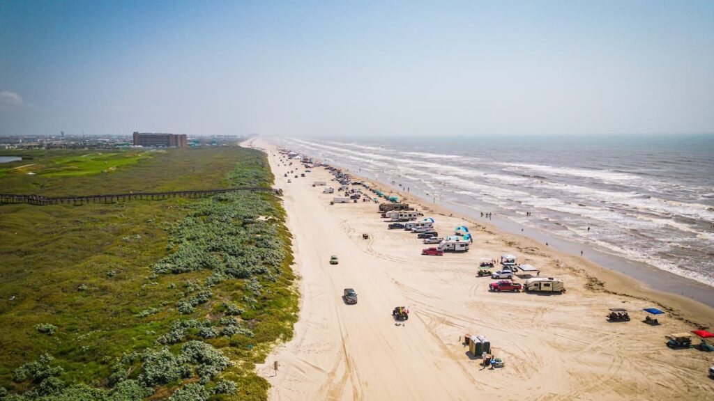 Numerous RVs cars and campervans on the beach in Corpus Christi in Texas