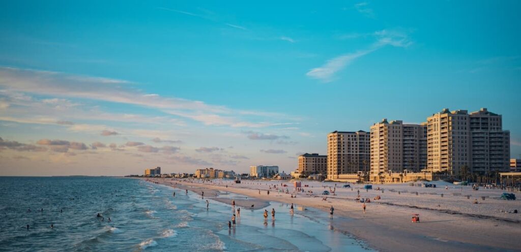 Crowds at Clearwater Beach with condominium complexes along the coastline