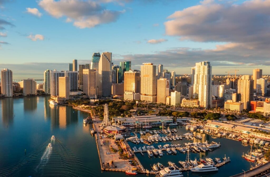 Aerial view of downtown Miami with the multiple boats in the marina and views of the skyscrappers