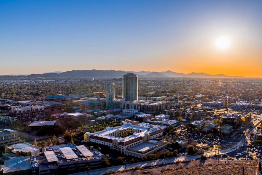 Aerial view of downtown Phoenix, Arizona with the sun rising in the background