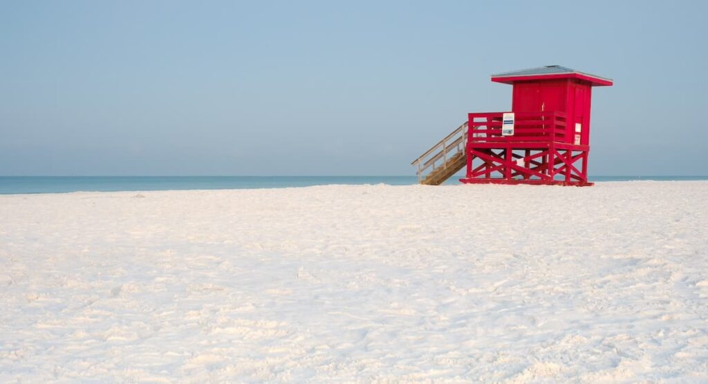 Red lifeguard hut on soft white sand at Siesta Key Beach Florida