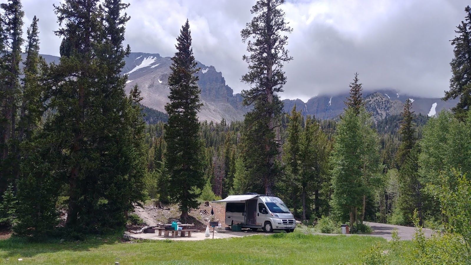 A serene campsite at Wheeler Peak Campground, nestled among aspen trees with mountain views.