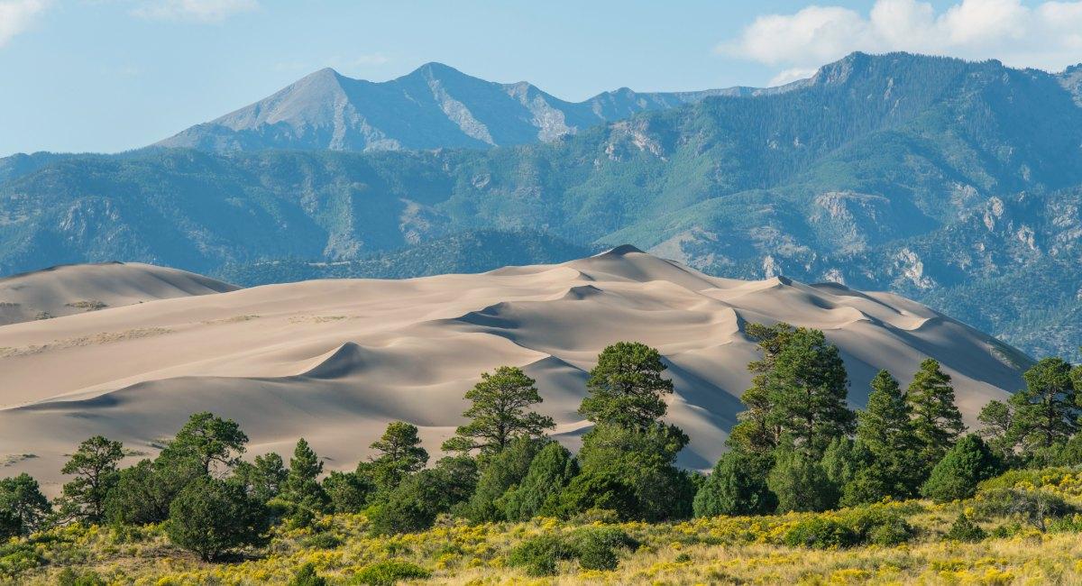 Great Sand Dunes National Park showing massive 750-foot sand dunes against Sangre de Cristo Mountains backdrop, RV camping destination from Colorado Springs