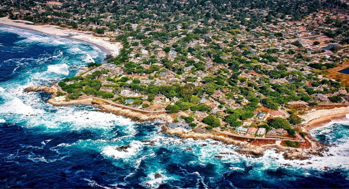 Aerial view of Carmel-by-the-Sea, California, with tree-lined neighbourhoods and rocky Pacific coastline