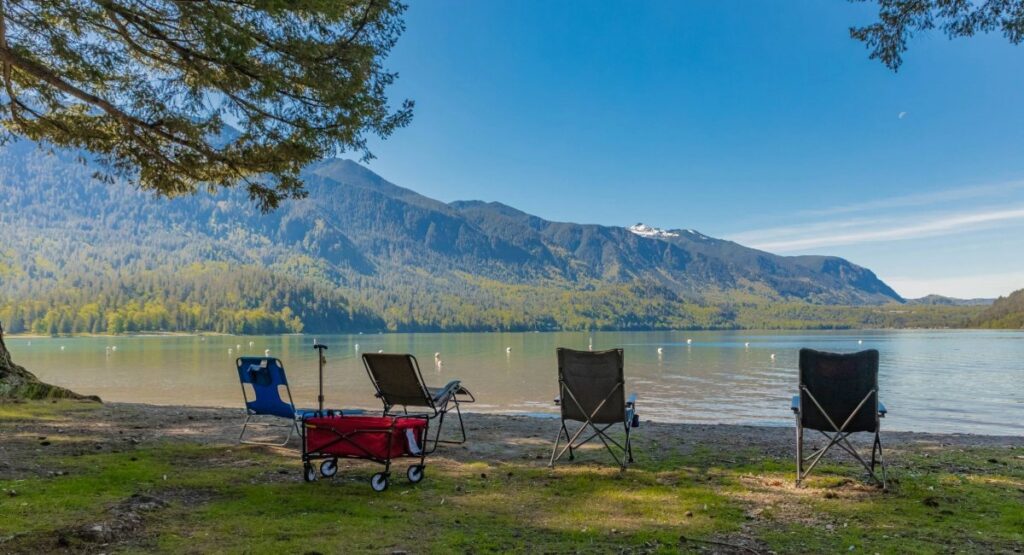 Lakeside RV camping at Cultus Lake Provincial Park with calm water, mountains, and family-friendly beach area in British Columbia